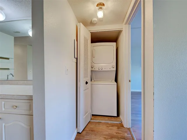 an empty room with windows and ceiling fan