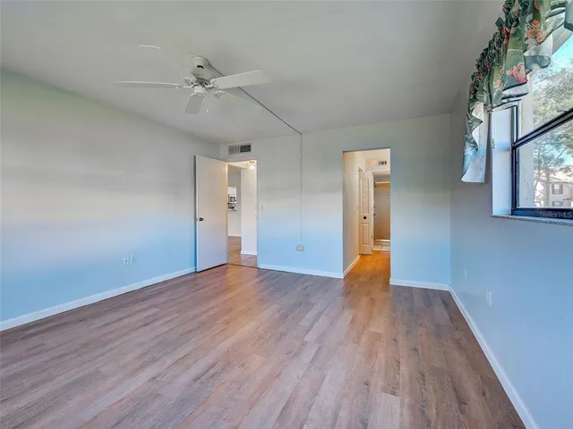 a living room with a floor to ceiling window and floor to ceiling window
