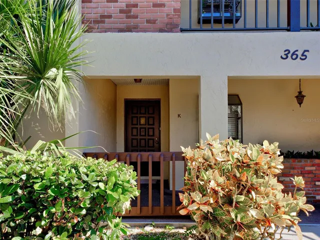 a view of a room with wooden floor and window