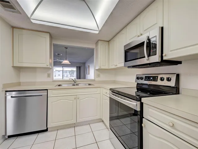 a view of empty room with wooden floor and window