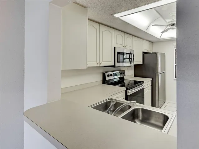 a view of a livingroom with wooden floor and a ceiling fan