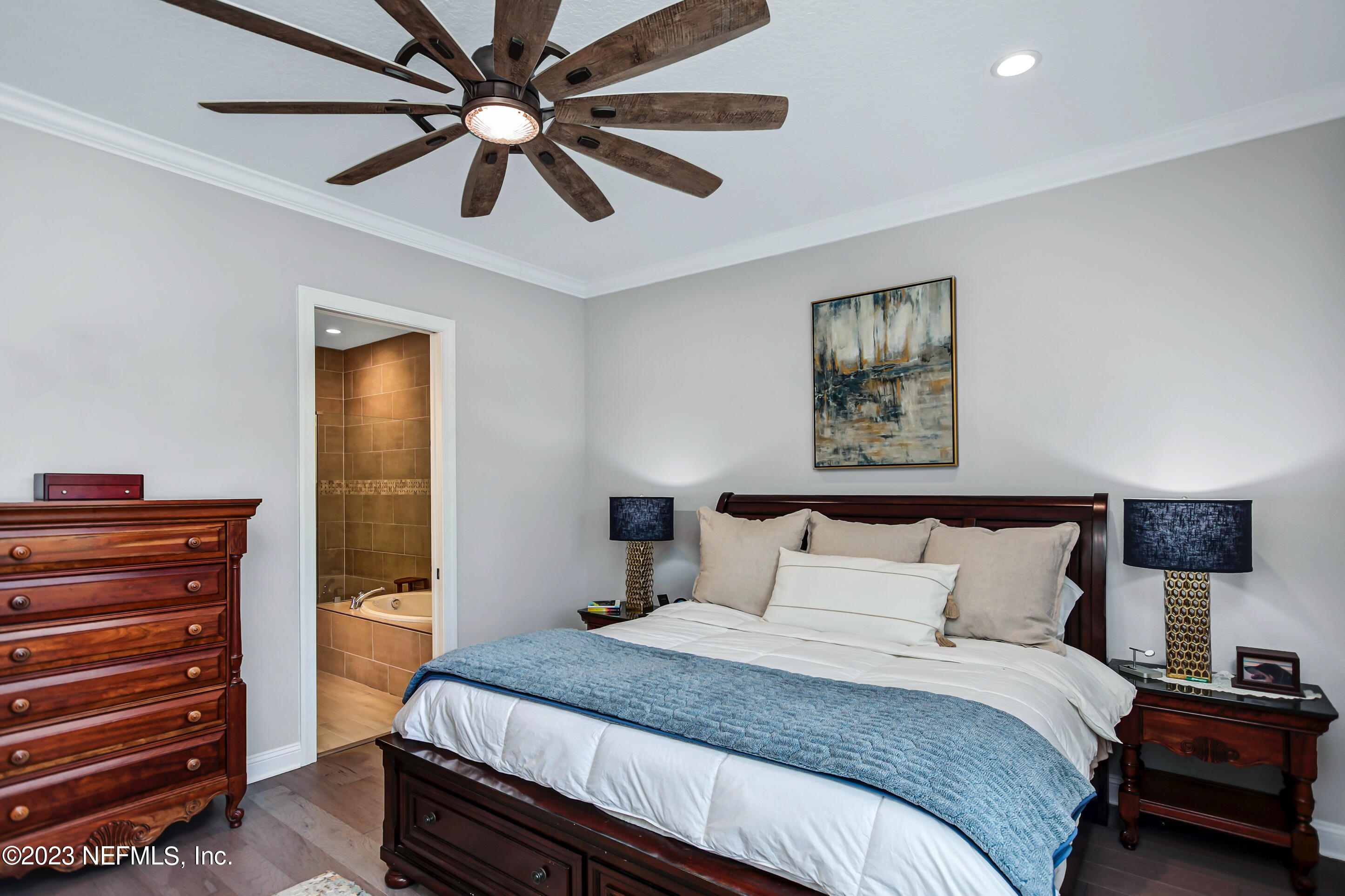 67 Carousel Drive Ponte Vedra, FL 32081 - Photo 14 of 30 a bedroom with a bed and a chandelier