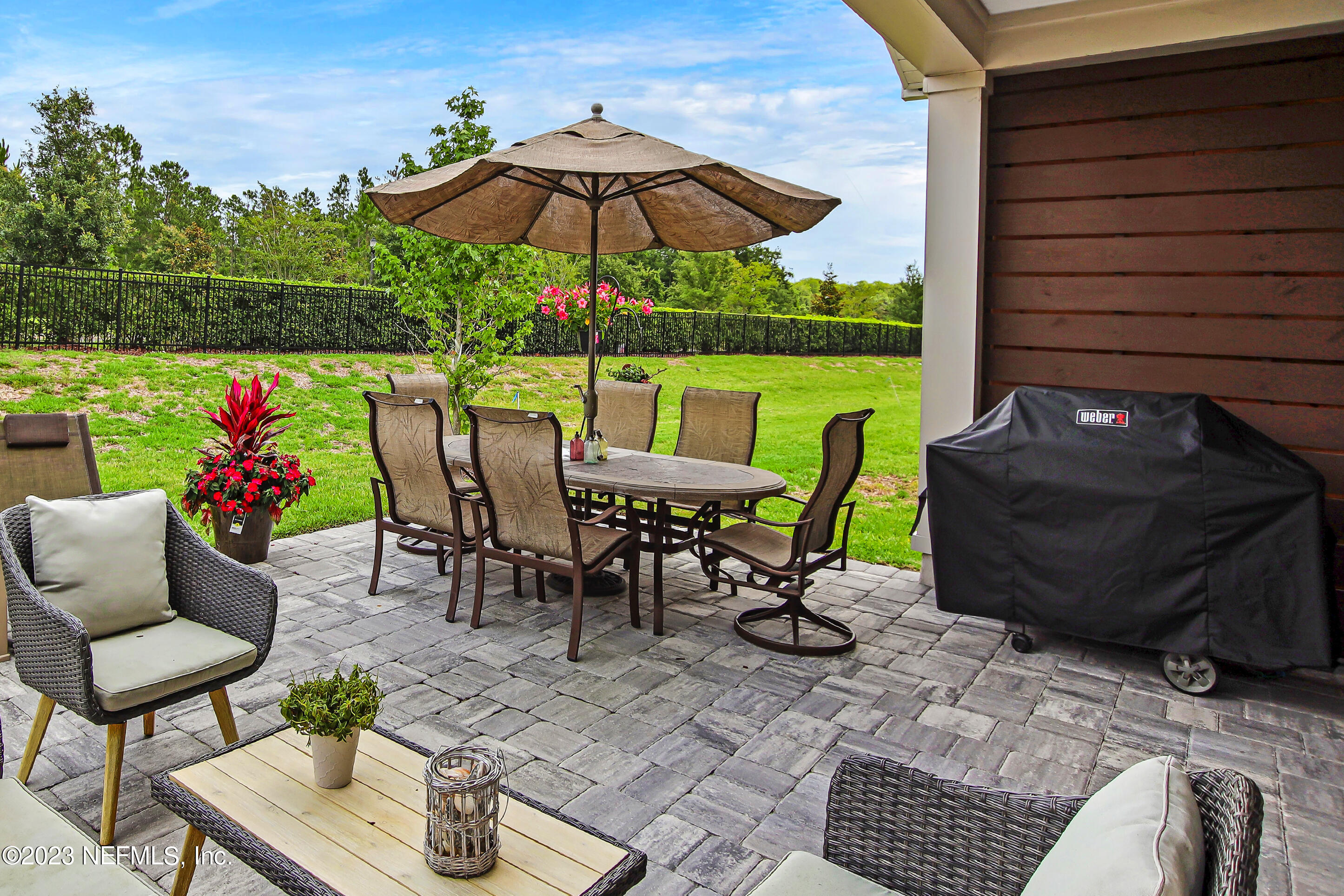 67 Carousel Drive Ponte Vedra, FL 32081 - Photo 27 of 30 a view of a patio with a table chairs and a potted plant