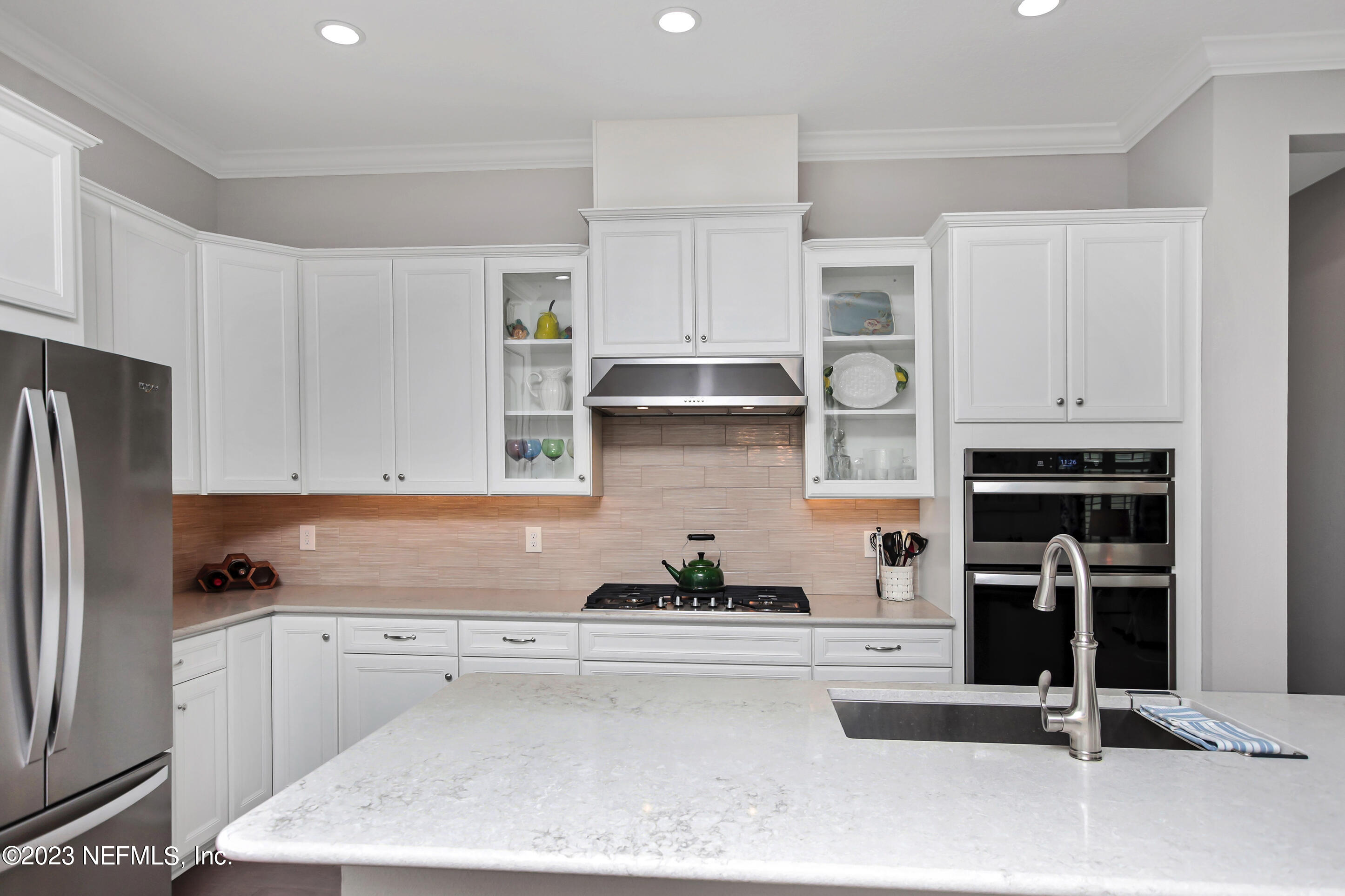 67 Carousel Drive Ponte Vedra, FL 32081 - Photo 6 of 30 a kitchen with stainless steel appliances granite countertop a refrigerator and a stove top oven