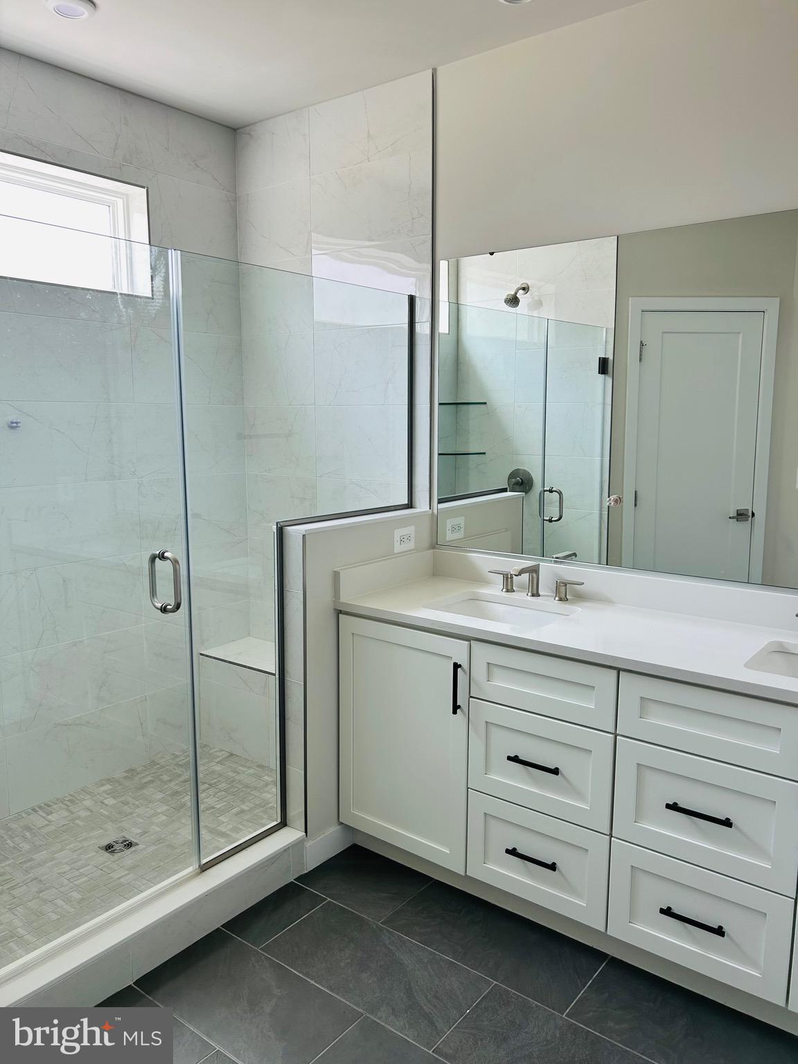 22351 Roanoke Rise Terrace Ashburn, VA 20148 - Photo 15 of 28 a bathroom with a shower sink and mirror