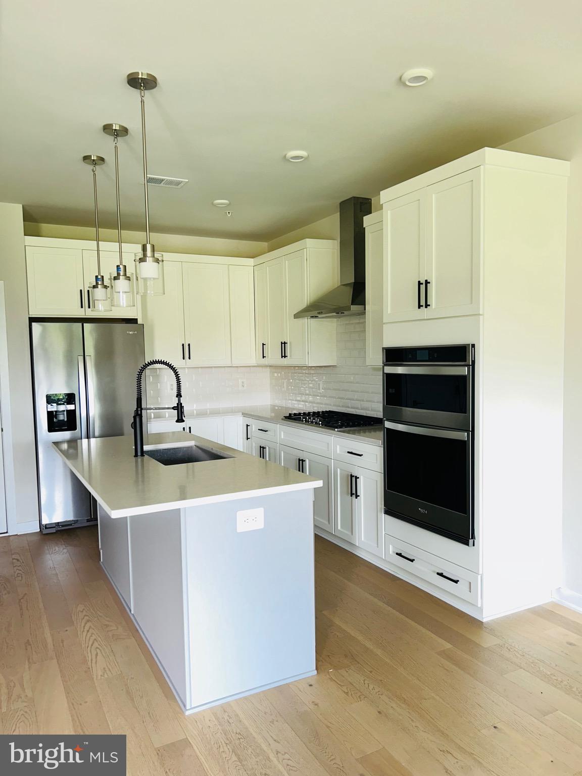 22351 Roanoke Rise Terrace Ashburn, VA 20148 - Photo 2 of 28 a kitchen with stainless steel appliances granite countertop a sink a stove and a refrigerator