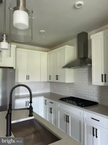 a kitchen with stainless steel appliances granite countertop a sink and cabinets