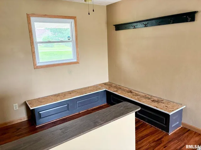 a area with a wooden floor and a window