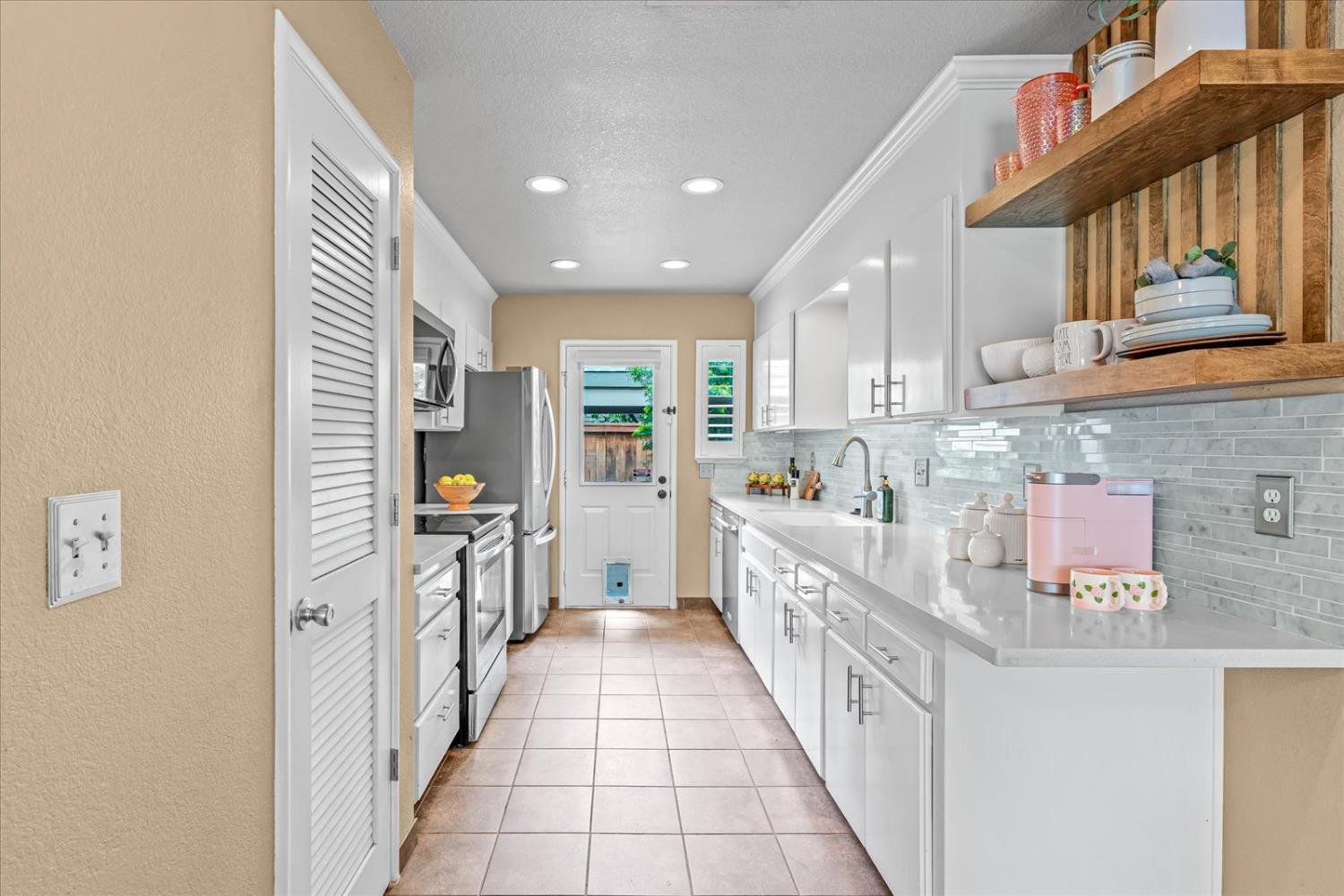 750 Lincoln Road, Unit 58 Yuba City, CA 95991 - Photo 28 of 69 a kitchen with kitchen island granite countertop lots of counter top space and stainless steel appliances