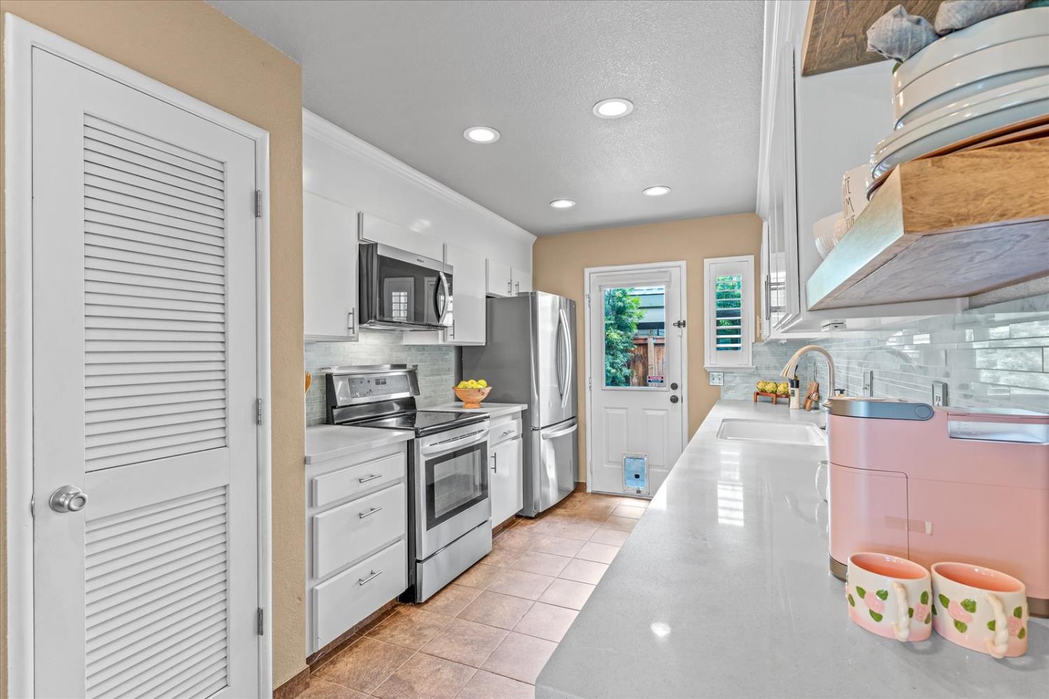 750 Lincoln Road, Unit 58 Yuba City, CA 95991 - Photo 29 of 69 a kitchen with stainless steel appliances granite countertop a refrigerator a stove and a sink with wooden floor