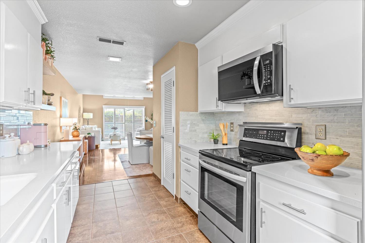 750 Lincoln Road, Unit 58 Yuba City, CA 95991 - Photo 33 of 69 a kitchen with stainless steel appliances a stove microwave and cabinets