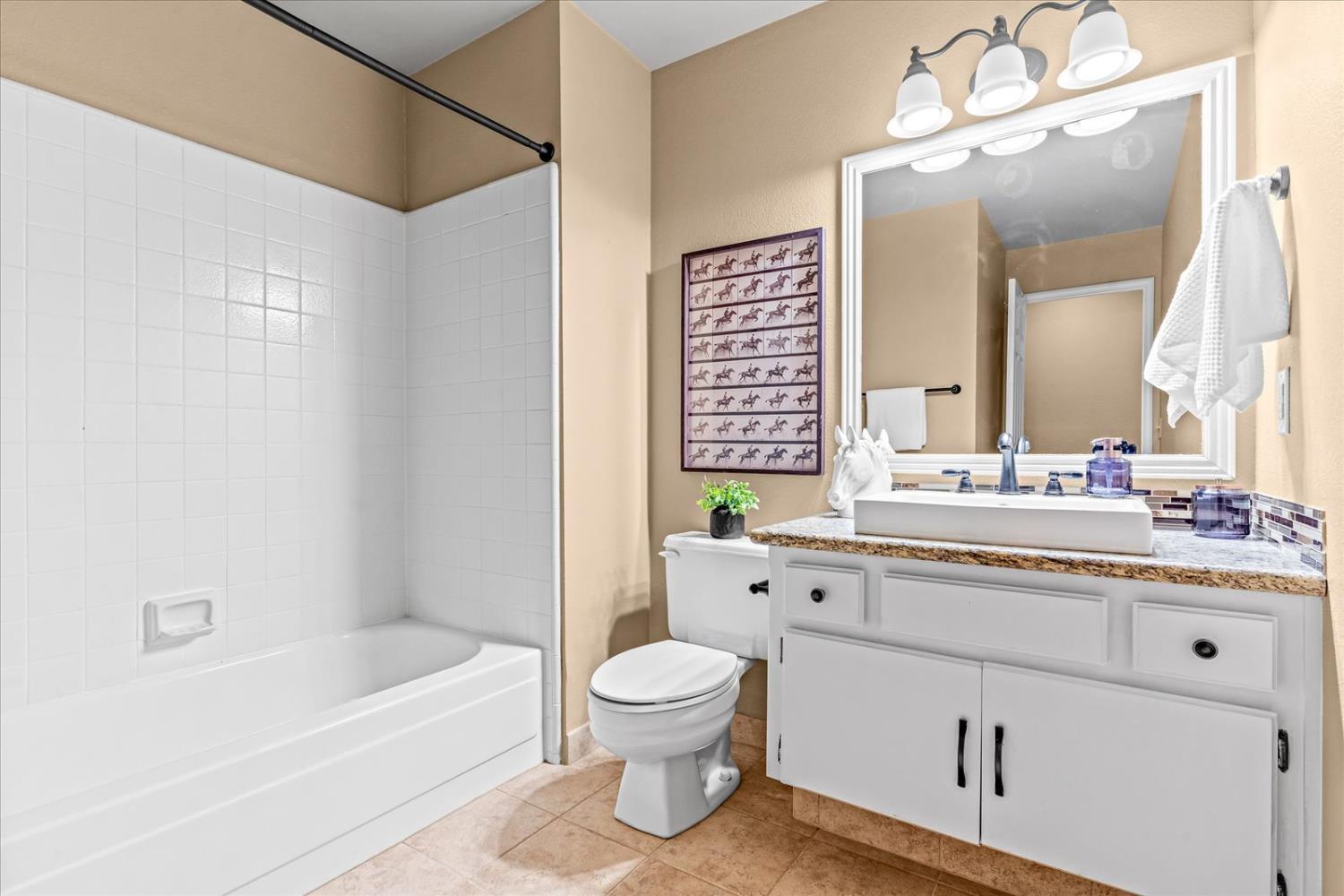 750 Lincoln Road, Unit 58 Yuba City, CA 95991 - Photo 42 of 69 a bathroom with a granite countertop sink a toilet and a bathtub