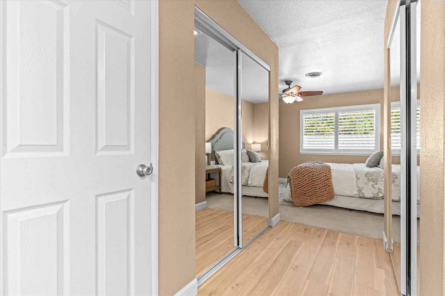 750 Lincoln Road, Unit 58 Yuba City, CA 95991 - Photo 55 of 69 a bedroom with a bed and a walk in closet with wooden floor