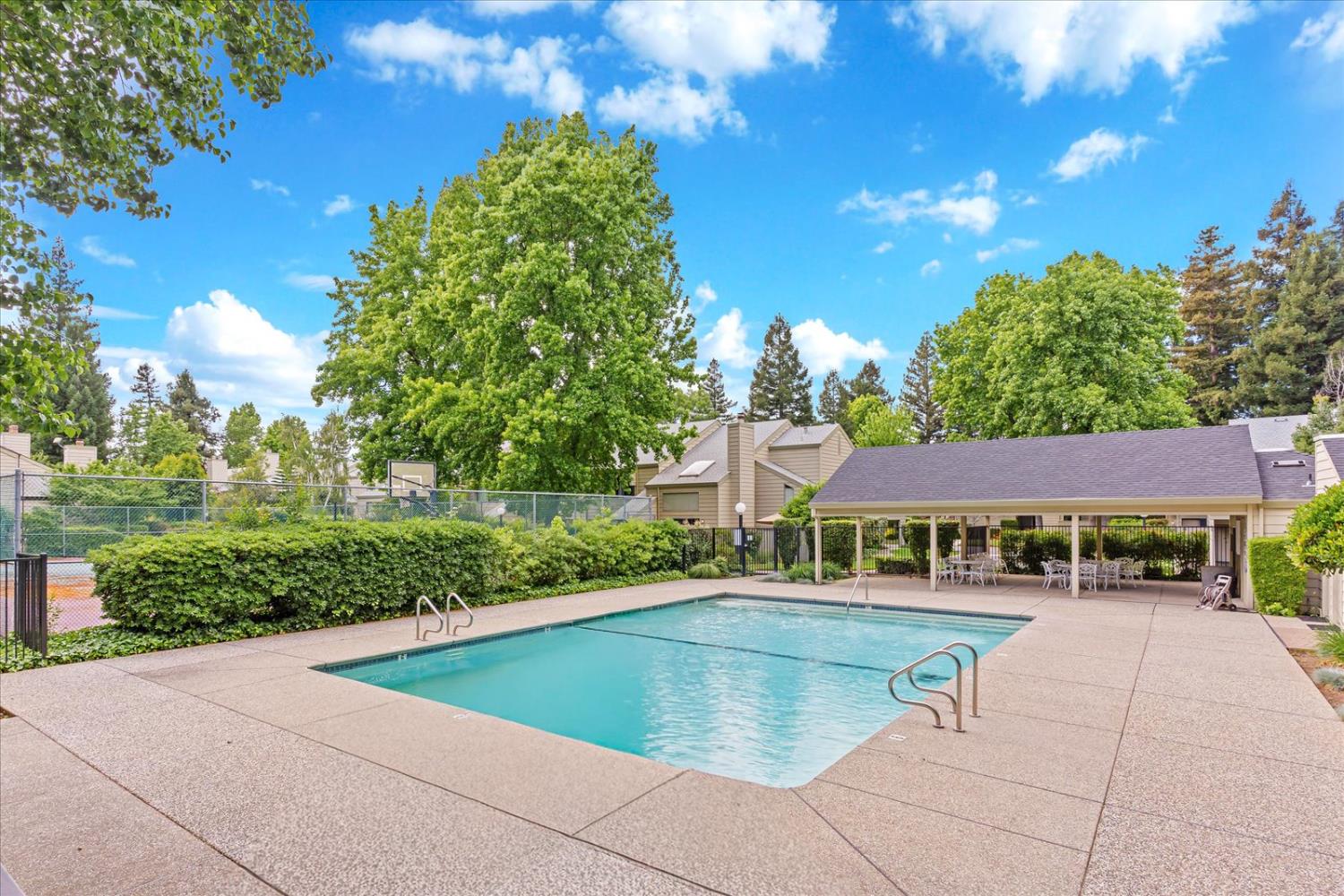 750 Lincoln Road, Unit 58 Yuba City, CA 95991 - Photo 67 of 69 a view of swimming pool with outdoor seating and trees in the background
