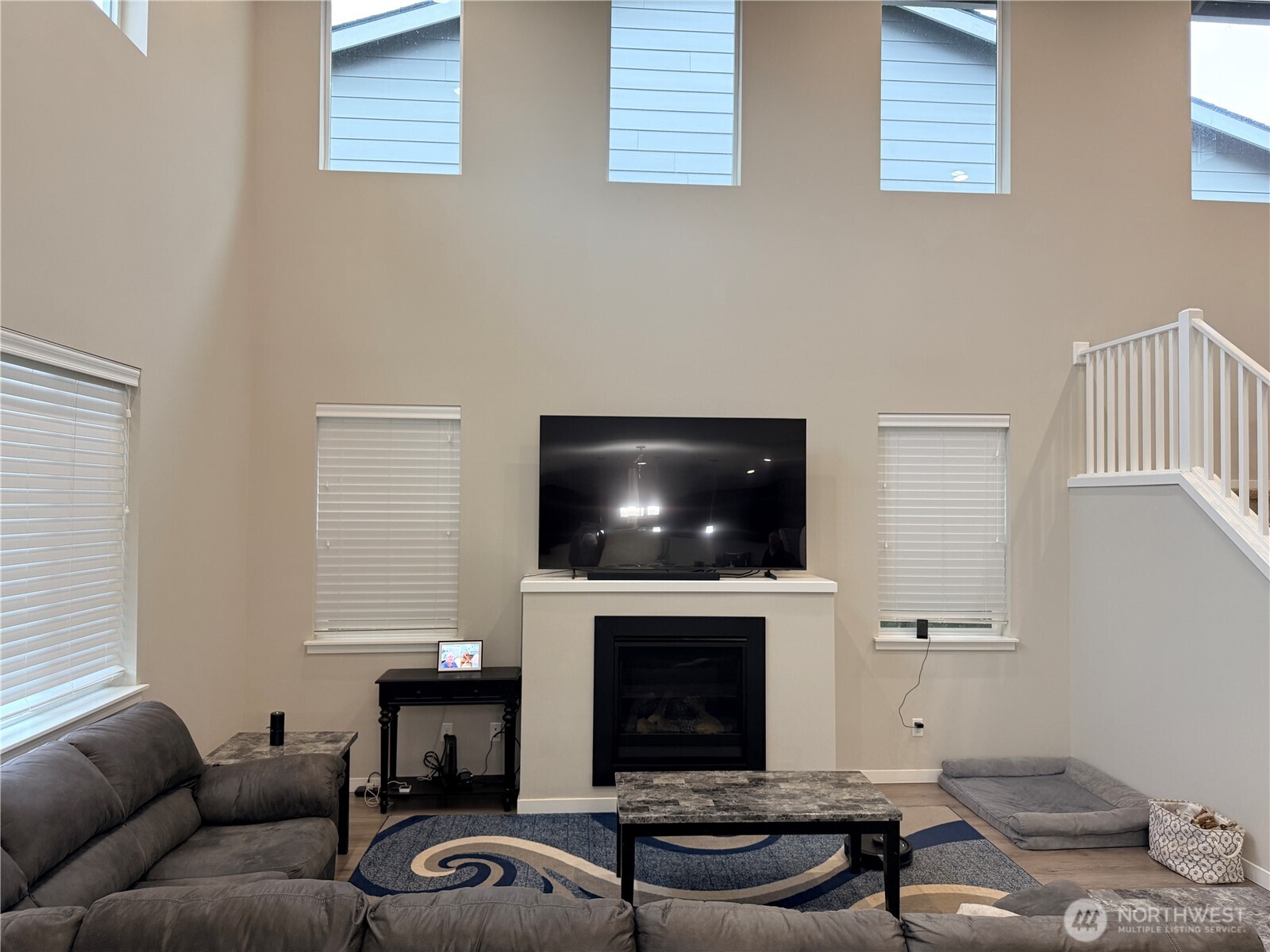 4880 Limerick Drive Southwest Port Orchard, WA 98367 - Photo 17 of 38 a living room with furniture a fireplace and a flat screen tv