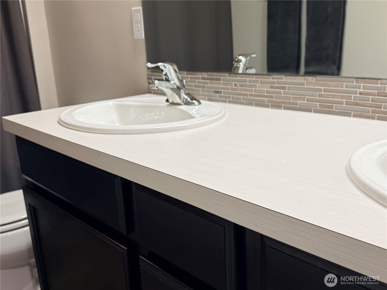 4880 Limerick Drive Southwest Port Orchard, WA 98367 - Photo 32 of 38 a bathroom with a sink and a mirror