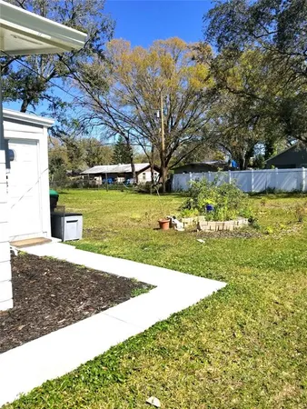a view of a patio with a table and chairs under an umbrella