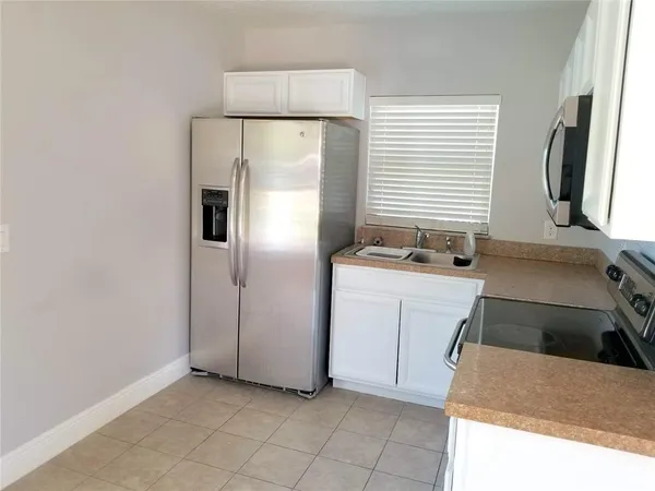 a kitchen with a sink and a refrigerator