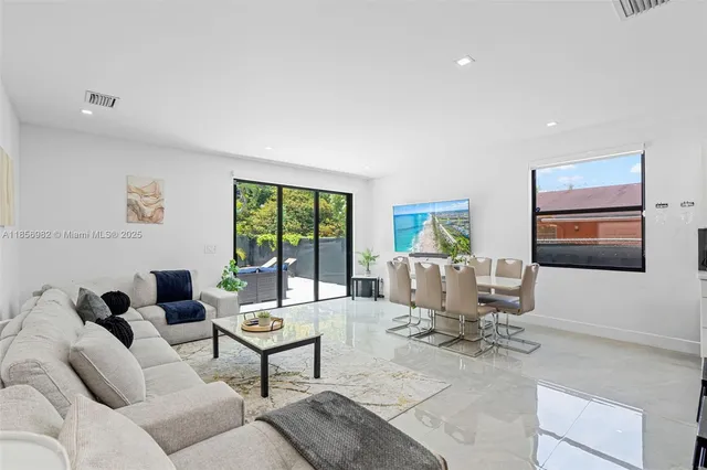 a living room with furniture or couch and a large window