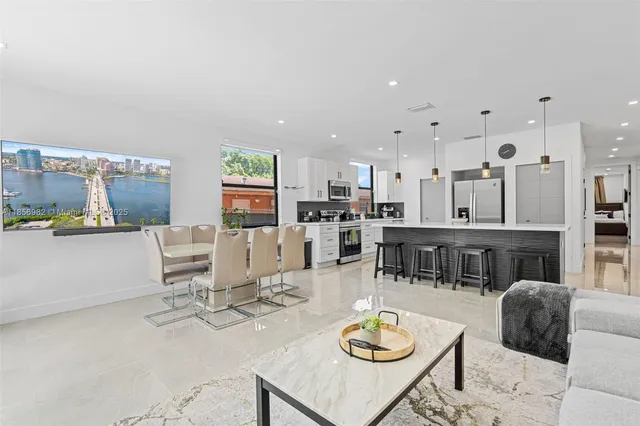 a living room with lots of furniture and kitchen view