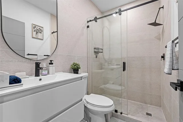 a bathroom with a sink toilet and shower