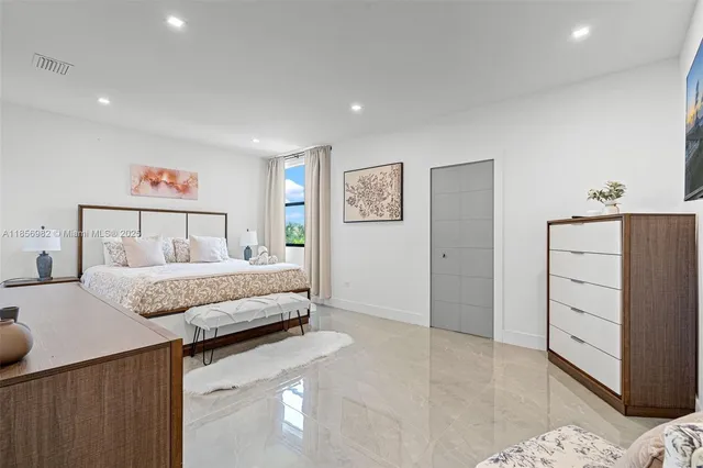 a spacious bedroom with a bed and a walk in closet