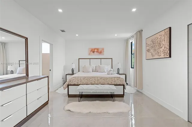 a spacious bedroom with a bed and a cabinets