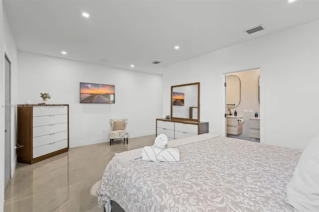 a bedroom with a bed and a dresser