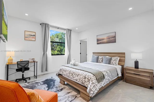 a bedroom with a large bed and a window