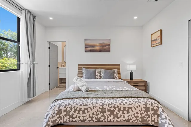 a bed room with a bed and a chair