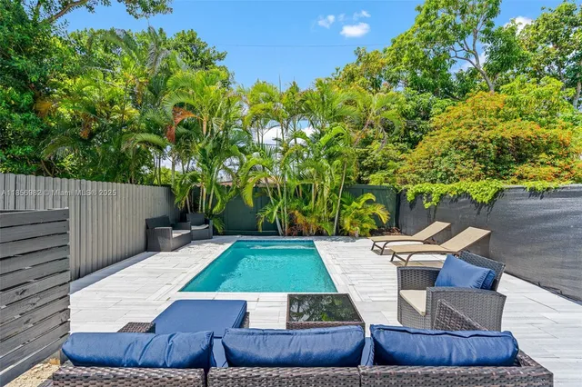 a view of a backyard with sitting area