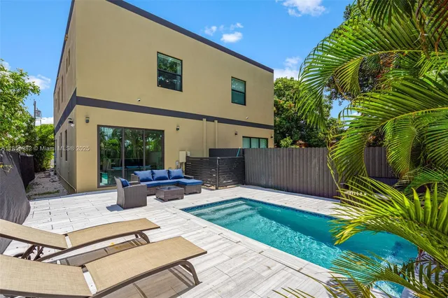 a view of a backyard with sitting area