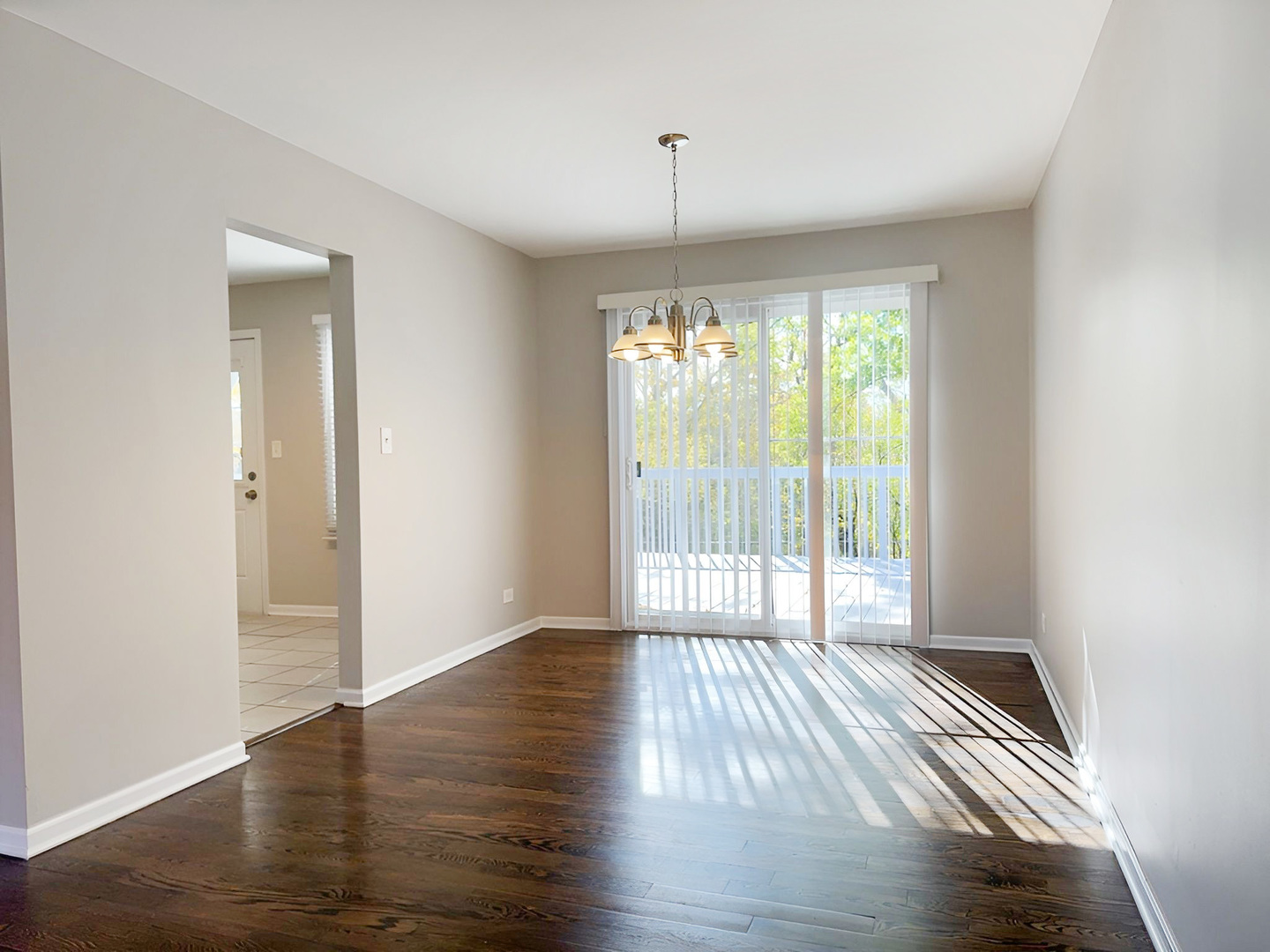 533 Surryse Road Lake Zurich, IL 60047 - Photo 13 of 51 a view of an empty room with wooden floor and a window