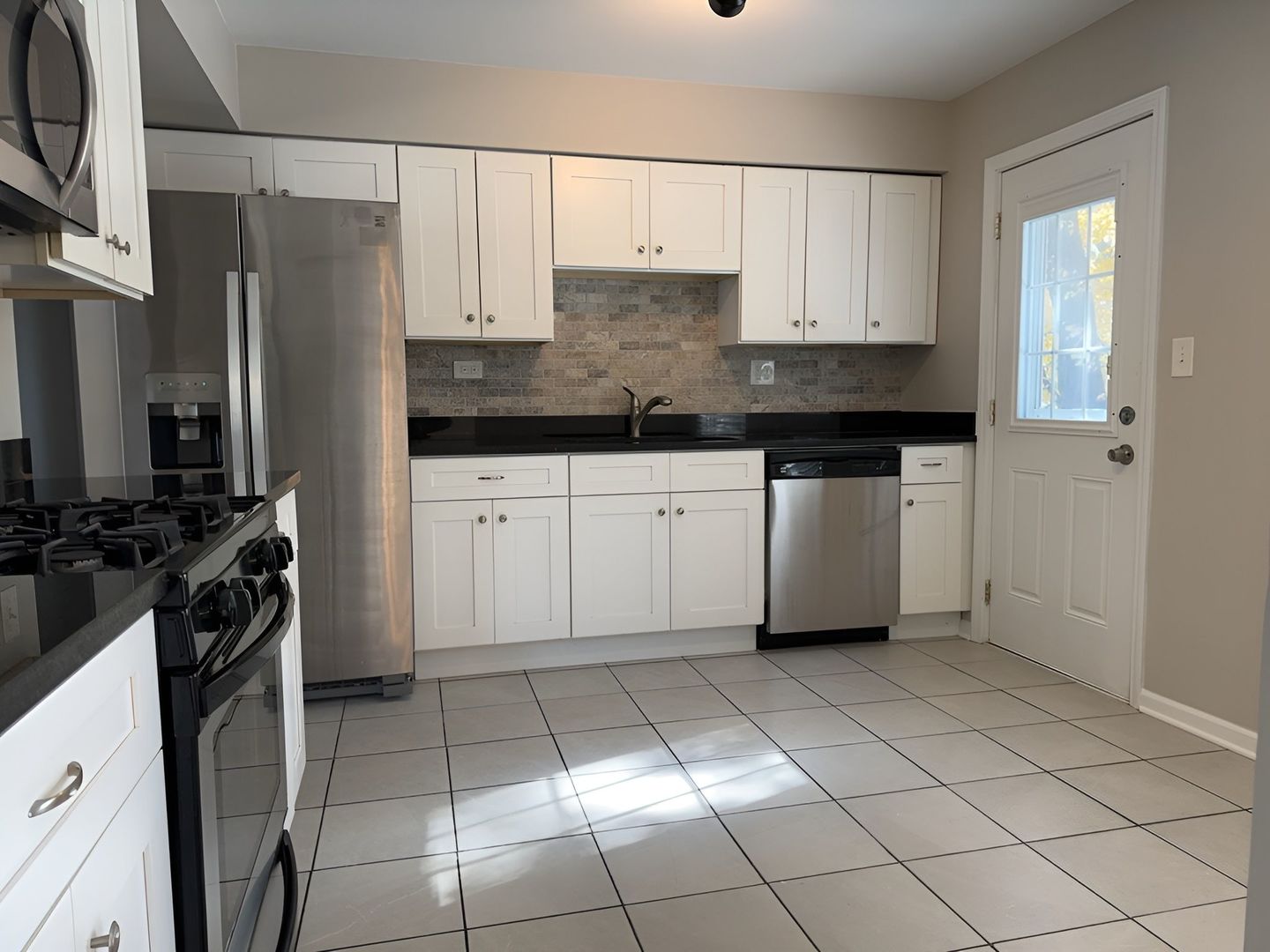 533 Surryse Road Lake Zurich, IL 60047 - Photo 15 of 51 a kitchen with a refrigerator sink and cabinets