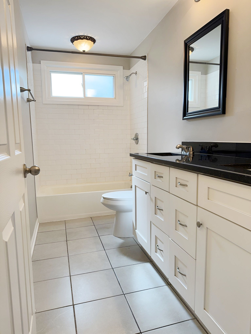 533 Surryse Road Lake Zurich, IL 60047 - Photo 31 of 51 a bathroom with a granite countertop sink a toilet and a mirror