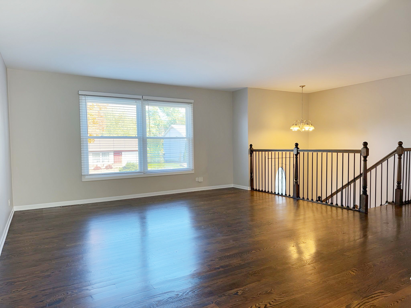 533 Surryse Road Lake Zurich, IL 60047 - Photo 10 of 51 a view of an empty room with wooden floor and a window