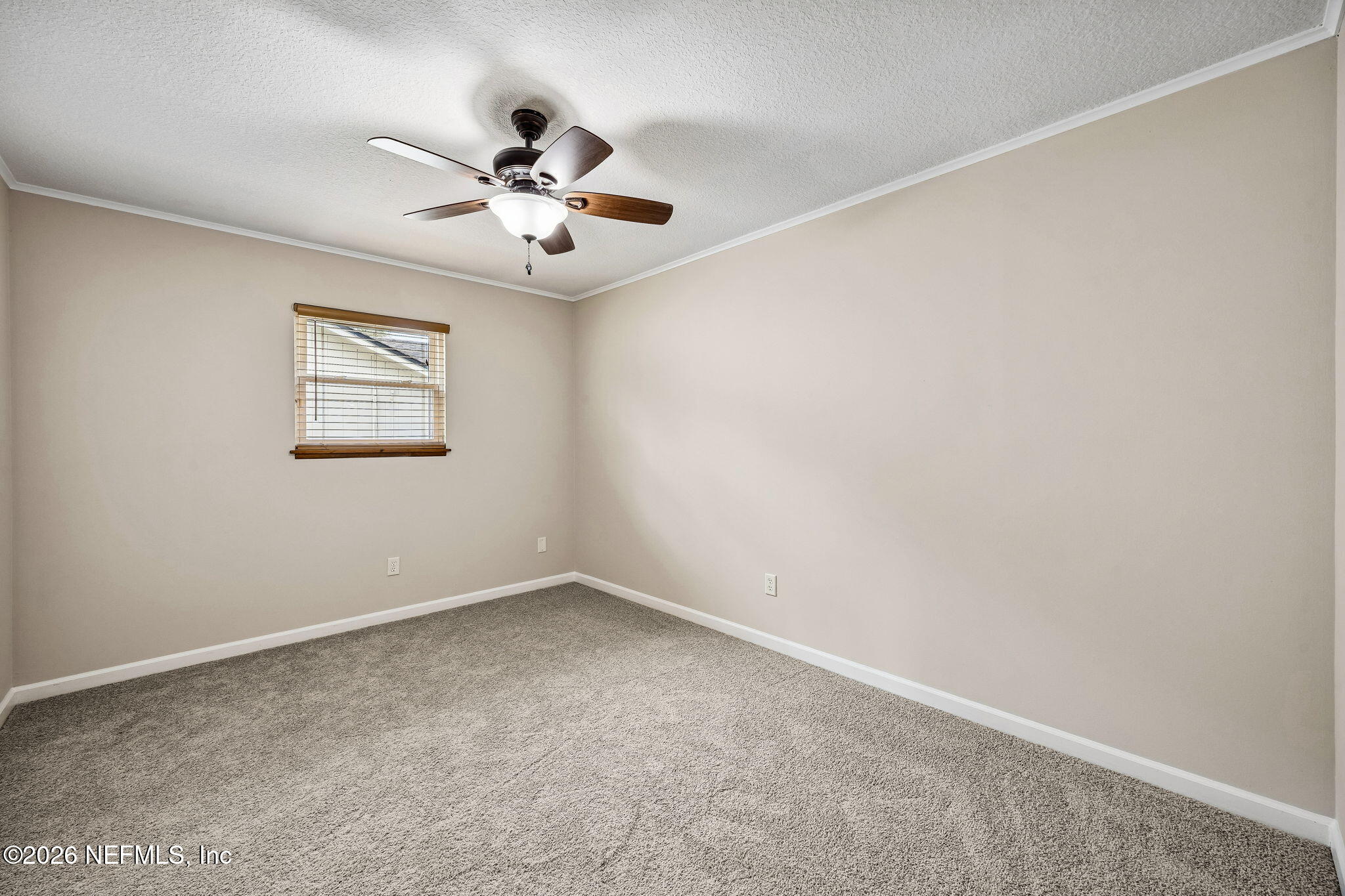 1888 Clemson Road Jacksonville, FL 32217 - Photo 19 of 41 an empty room with a window and a fan