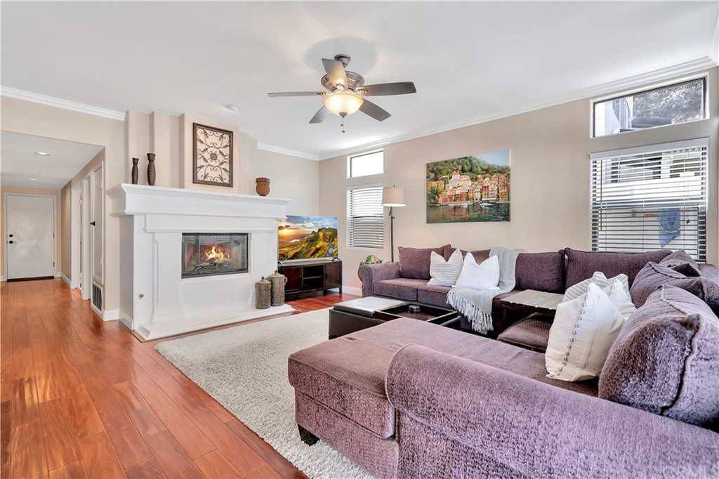 1600 Canyon Crest Circle Corona, CA 92882 - Photo 26 of 74 a living room with furniture a fireplace and a flat screen tv