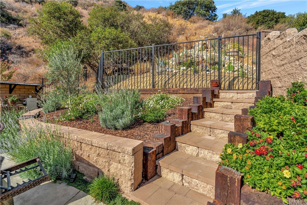 1600 Canyon Crest Circle Corona, CA 92882 - Photo 31 of 74 a view of a chair and table in the backyard
