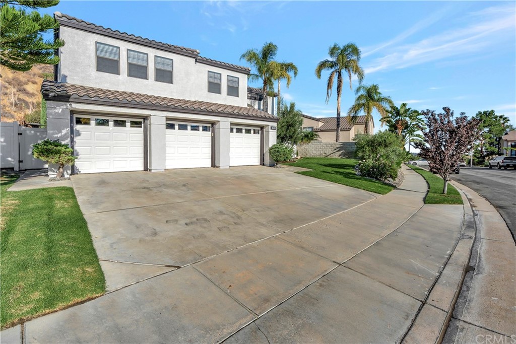 1600 Canyon Crest Circle Corona, CA 92882 - Photo 37 of 74 a front view of a house with a garden and trees
