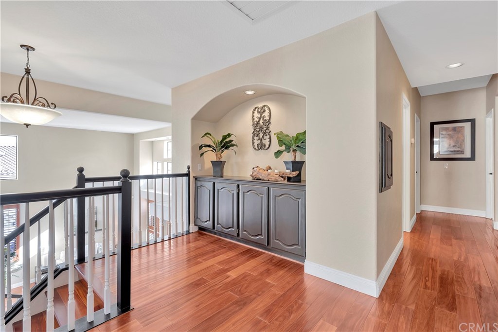 1600 Canyon Crest Circle Corona, CA 92882 - Photo 39 of 74 a view of a hallway with wooden floor and stairs