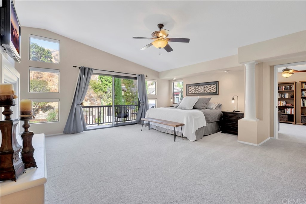 1600 Canyon Crest Circle Corona, CA 92882 - Photo 40 of 74 a spacious bedroom with a large bed and a chandelier