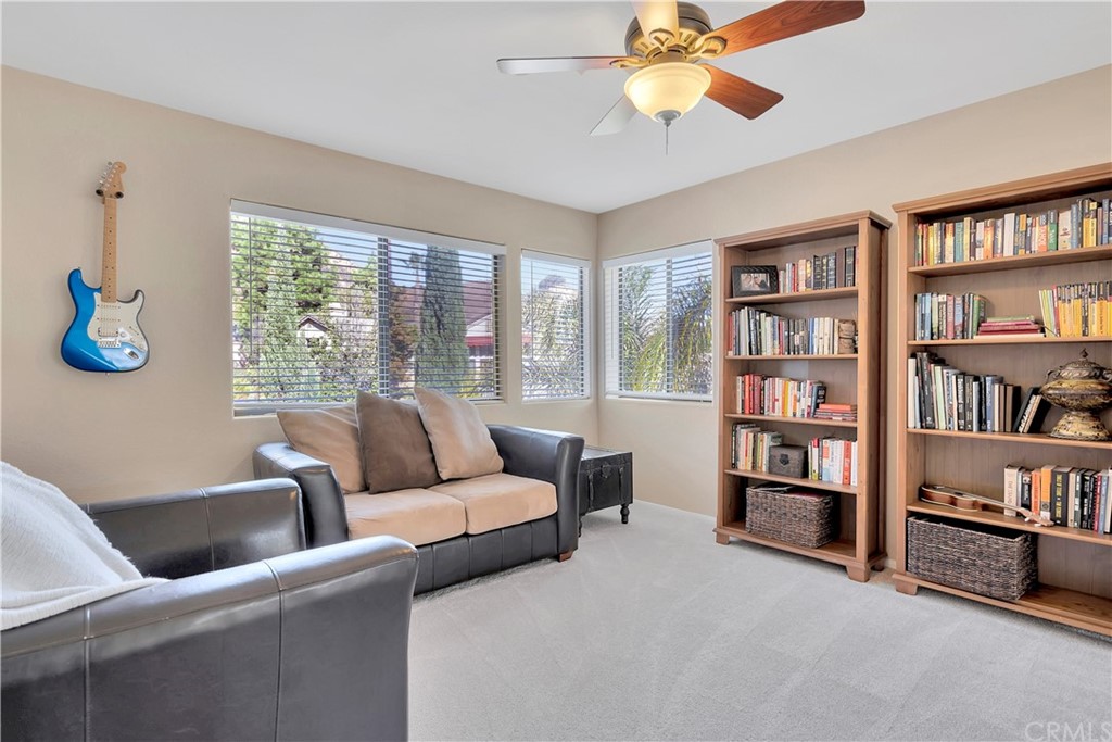 1600 Canyon Crest Circle Corona, CA 92882 - Photo 46 of 74 a living room with furniture and a book shelf