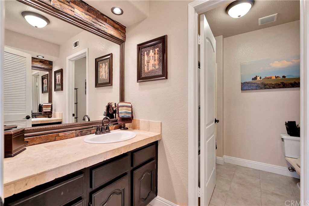 1600 Canyon Crest Circle Corona, CA 92882 - Photo 53 of 74 a bathroom with a sink and a mirror