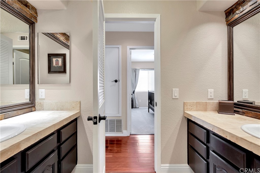 1600 Canyon Crest Circle Corona, CA 92882 - Photo 54 of 74 a bathroom with a sink and a mirror