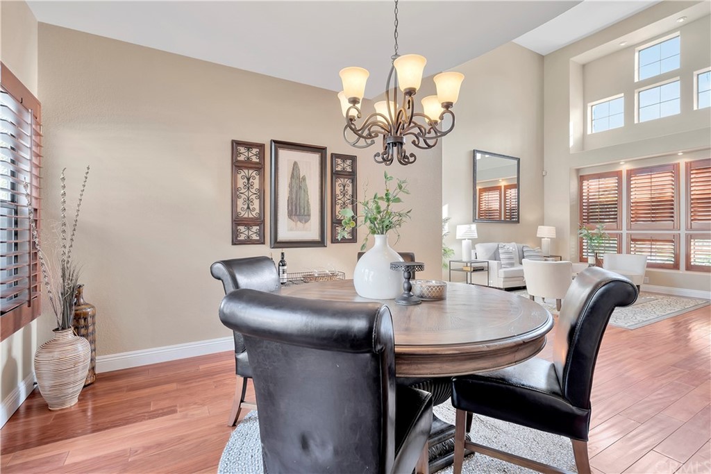 1600 Canyon Crest Circle Corona, CA 92882 - Photo 58 of 74 a view of a dining room with furniture wooden floor and chandelier