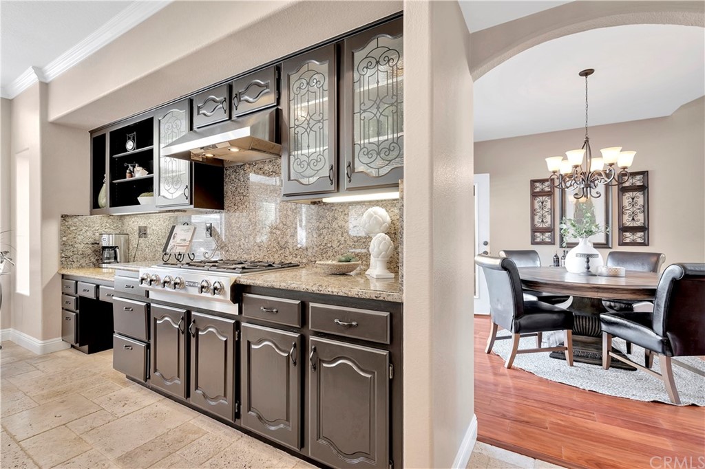 1600 Canyon Crest Circle Corona, CA 92882 - Photo 61 of 74 a kitchen with kitchen island granite countertop a stove a sink and a refrigerator