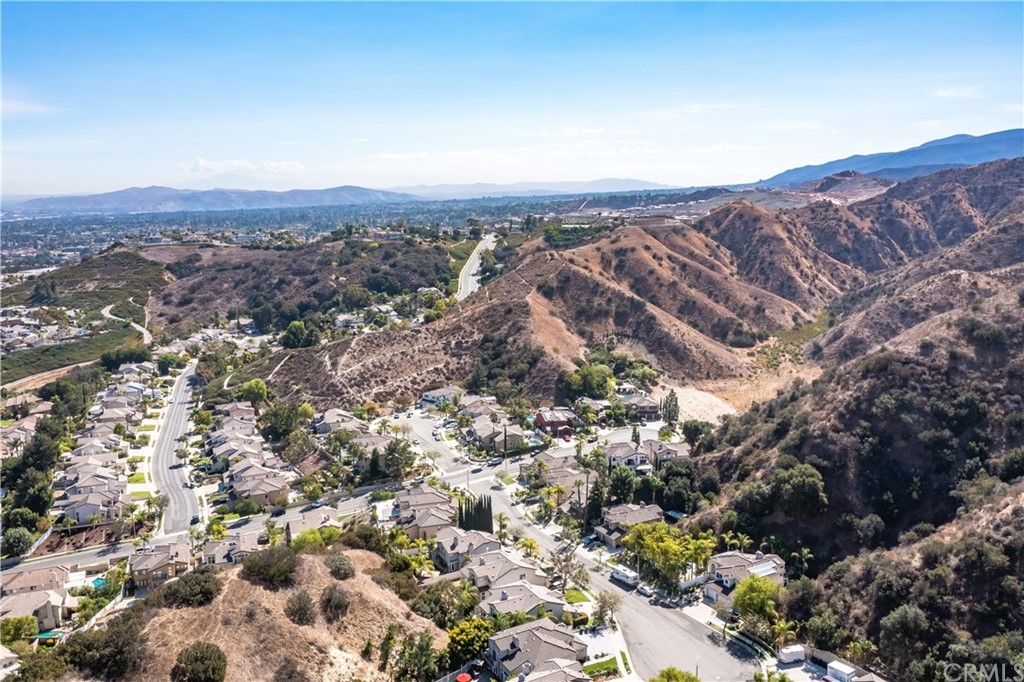 1600 Canyon Crest Circle Corona, CA 92882 - Photo 72 of 74 an aerial view of house with yard and mountain view in back