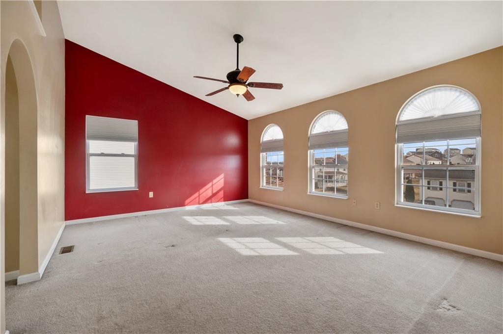 208 Commodore Drive McDonald, PA 15057 - Photo 16 of 36 a view of an empty room with windows and ceiling fan