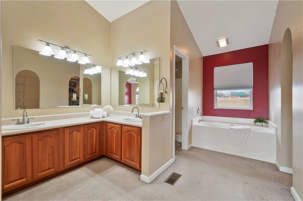 208 Commodore Drive McDonald, PA 15057 - Photo 18 of 36 a spacious bathroom with a double vanity sink mirror and a bathtub